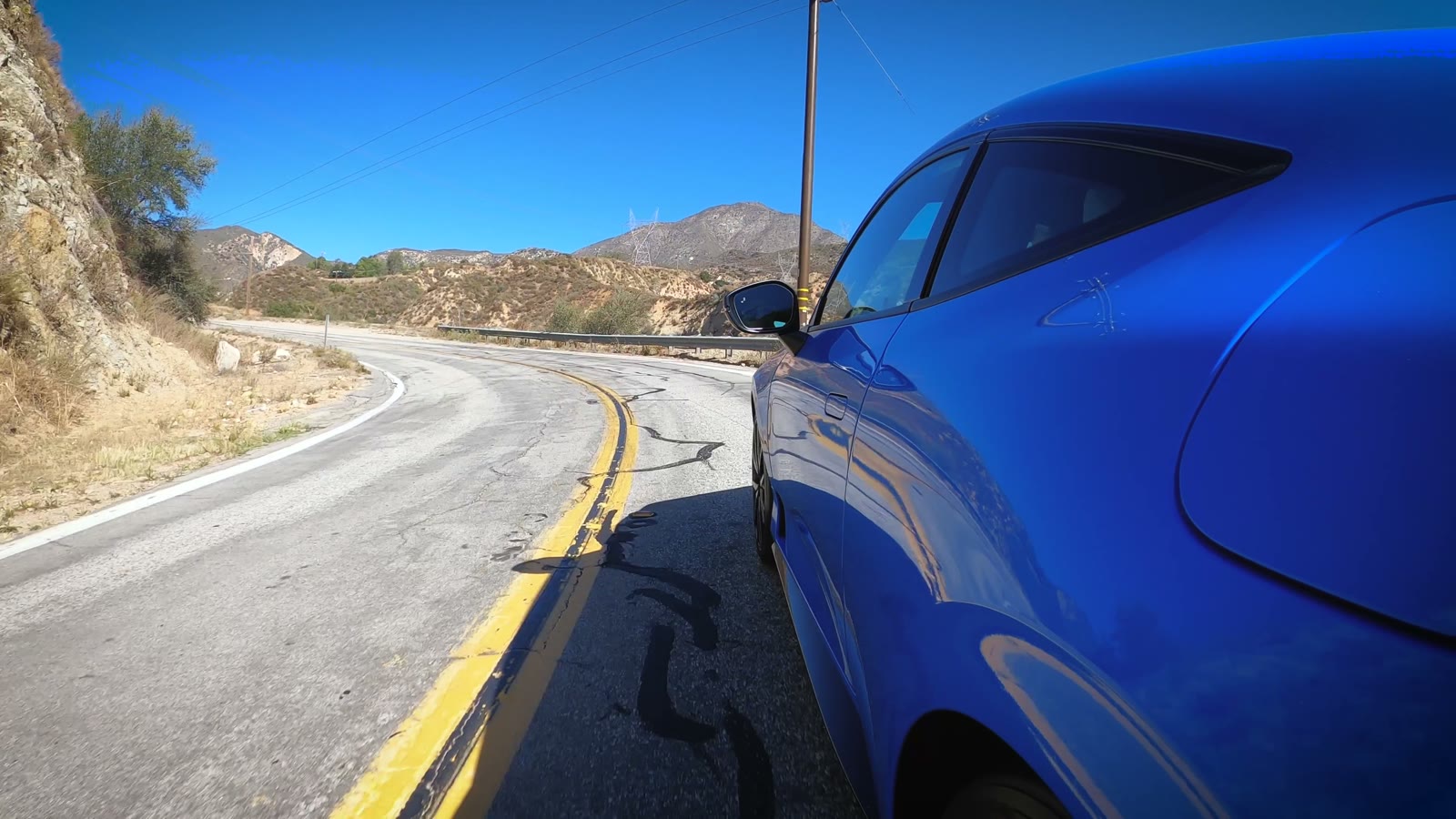 Blue 2026 Honda Prelude on a winding canyon road