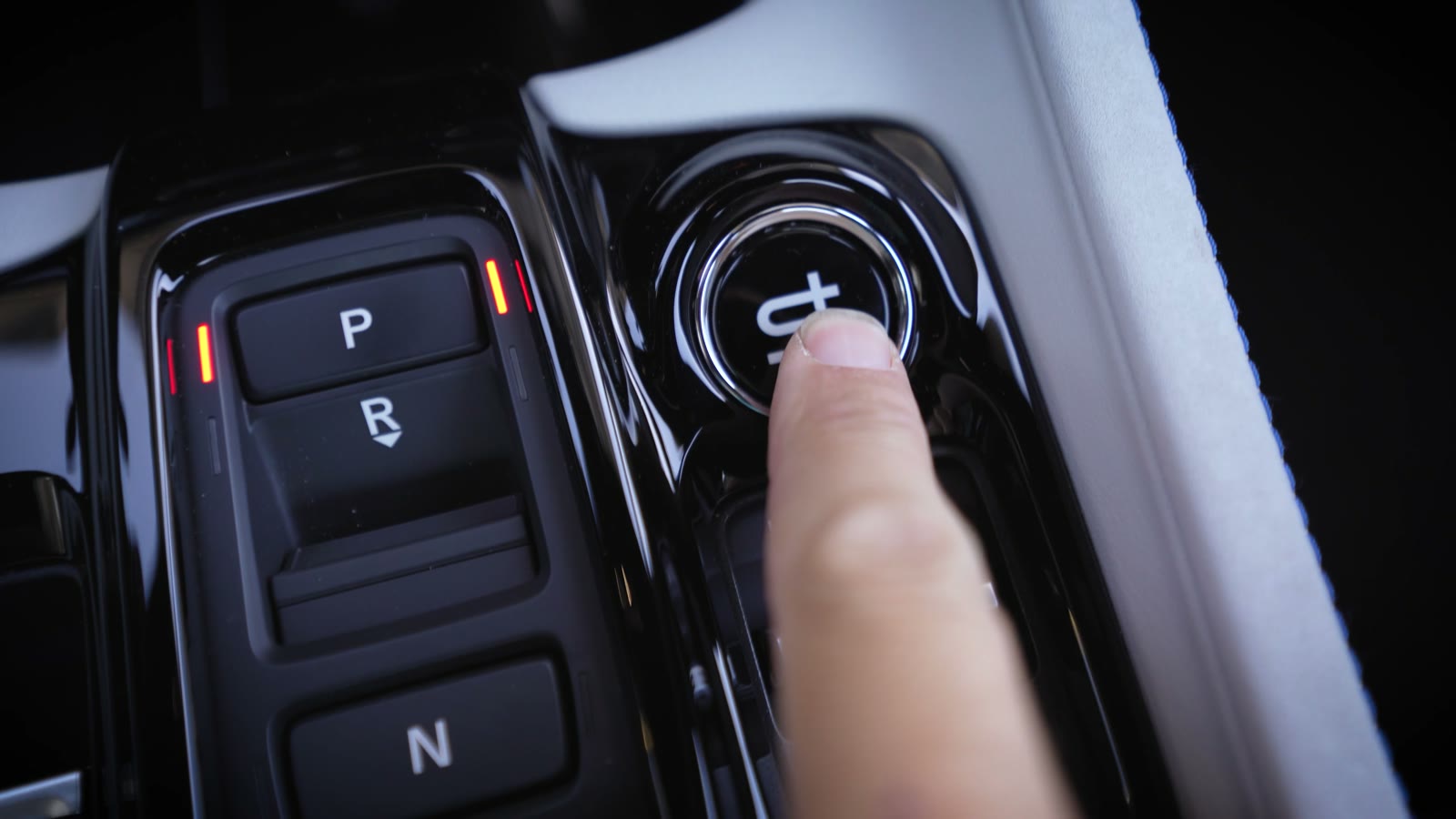 Finger pressing the S+ button next to the gear selector in a 2026 Honda Prelude